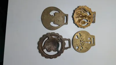 Sale Photo Thumbnail #320: Horse brass bridal medallions (or "horse brasses") are decorative, solid-brass plaques originally used to embellish the bridles and harnesses of working and parade horses. Originating in England in the mid-19th century, carters and farmers first used them