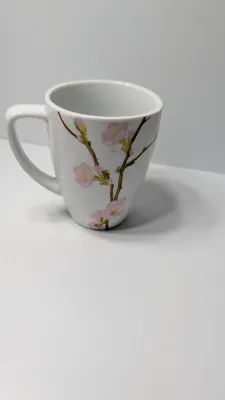 Sale Photo Thumbnail #326: Corelle Cherry Blossom Mugs are a popular discontinued dinnerware line prized for their elegant square silhouette and delicate pink and white floral motif. Unlike Corelle's signature Vitrelle glass plates, these coordinating mugs are crafted from durable,