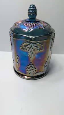 Sale Photo Thumbnail #270: This item is an original "Harvest Grape" (or simply "Harvest") pattern covered canister manufactured by the Indiana Glass Company.

Distinctive embossed clusters of grapes and large leaves, complete with a matching lid and textured finial.the pattern was 