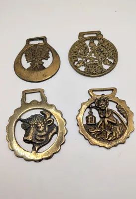 Sale Photo Thumbnail #314: Horse brass bridal medallions (or "horse brasses") are decorative, solid-brass plaques originally used to embellish the bridles and harnesses of working and parade horses. Originating in England in the mid-19th century, carters and farmers first used them