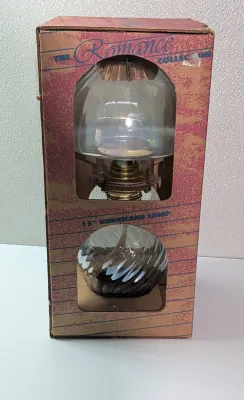 Sale Photo Thumbnail #467: Introducing a stunning addition to your vintage lamp collection - the Romance Collection 13" Glass Hurricane Oil Lamp. This exquisite piece comes in its original packaging and has never been used. Crafted from high-quality glass and finished with an oiled