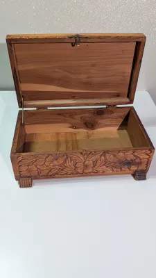 Sale Photo Thumbnail #447: The cedar box with the flower design has a broken latch

Vintage hand-carved cedar jewelry boxes featuring dovetail joints are highly sought-after mid-century collectibles, valued for their aromatic qualities, durability, and distinct folk-art aesthetic. 