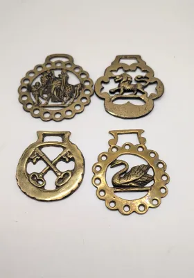 Sale Photo Thumbnail #303: Horse brass bridal medallions (or "horse brasses") are decorative, solid-brass plaques originally used to embellish the bridles and harnesses of working and parade horses. Originating in England in the mid-19th century, carters and farmers first used them