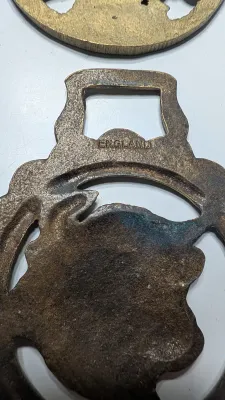 Sale Photo Thumbnail #321: Horse brass bridal medallions (or "horse brasses") are decorative, solid-brass plaques originally used to embellish the bridles and harnesses of working and parade horses. Originating in England in the mid-19th century, carters and farmers first used them