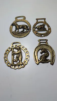 Sale Photo Thumbnail #291: Horse brass bridal medallions (or "horse brasses") are decorative, solid-brass plaques originally used to embellish the bridles and harnesses of working and parade horses. Originating in England in the mid-19th century, carters and farmers first used them