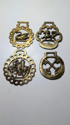 Sale Photo Thumbnail #304: Horse brass bridal medallions (or "horse brasses") are decorative, solid-brass plaques originally used to embellish the bridles and harnesses of working and parade horses. Originating in England in the mid-19th century, carters and farmers first used them