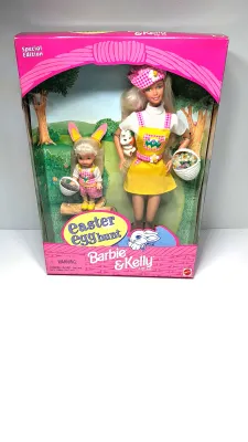 Sale Photo Thumbnail #364: Barbie Doll: Wears a vibrant yellow jumper with an Easter egg pattern pocket, a white t-shirt, a matching pink plaid hat, and shoes.Kelly Doll: Dressed in matching pink plaid overalls, a white t-shirt, and adorable bunny ears.Accessories Included: The set