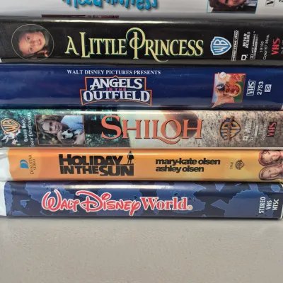 LOT 27B: Vintage VHS Clamshell Collection with Sealed "The Goonies" Movie