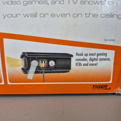 LOT 56B: Tiger Electronics Zoombox Portable Projector DVD/CD Player with Apollo Portable Projection Screen with Tripod Metal Base