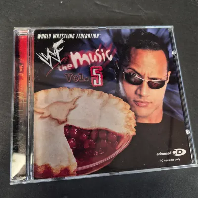 LOT 32B: WWF CD Collection with Mick Foley's Christmas Chaos Book & Bret Hitman Hart Book