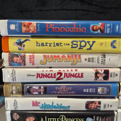 LOT 27B: Vintage VHS Clamshell Collection with Sealed "The Goonies" Movie