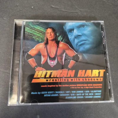 LOT 32B: WWF CD Collection with Mick Foley's Christmas Chaos Book & Bret Hitman Hart Book