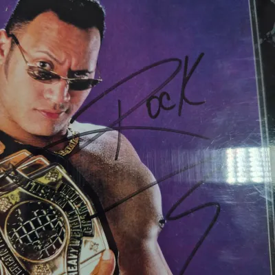 LOT 192Z: Stone Cold & The Rock Autographed Plaques, 1999 WWF WrestleMania T-Shirt & More