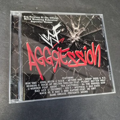 LOT 32B: WWF CD Collection with Mick Foley's Christmas Chaos Book & Bret Hitman Hart Book