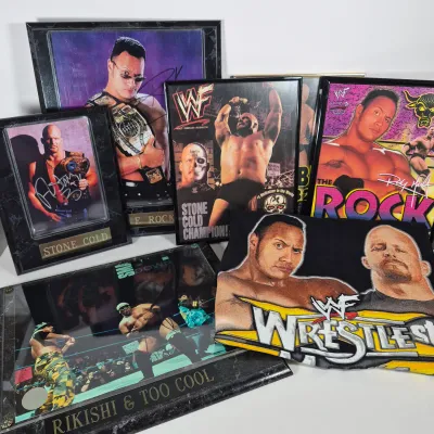 LOT 192Z: Stone Cold & The Rock Autographed Plaques, 1999 WWF WrestleMania T-Shirt & More