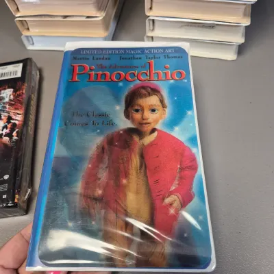 LOT 27B: Vintage VHS Clamshell Collection with Sealed "The Goonies" Movie