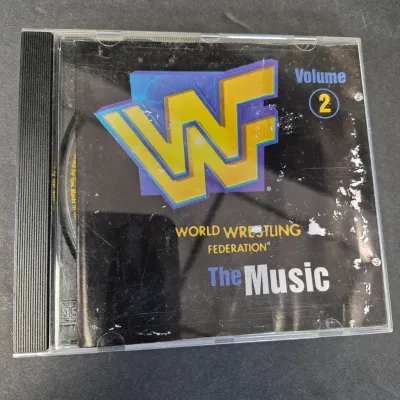 LOT 32B: WWF CD Collection with Mick Foley's Christmas Chaos Book & Bret Hitman Hart Book