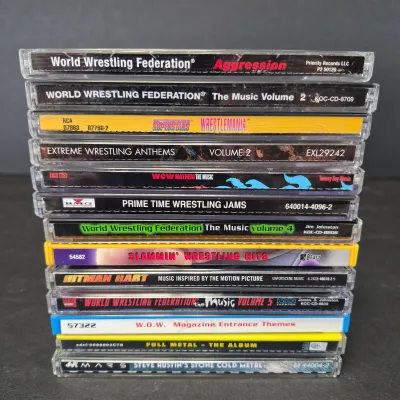 LOT 32B: WWF CD Collection with Mick Foley's Christmas Chaos Book & Bret Hitman Hart Book