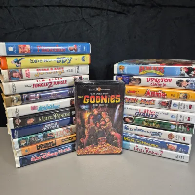 LOT 27B: Vintage VHS Clamshell Collection with Sealed "The Goonies" Movie