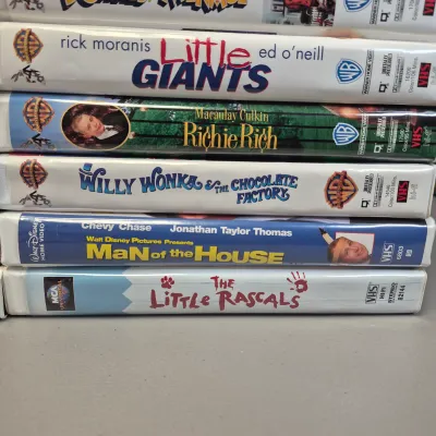 LOT 27B: Vintage VHS Clamshell Collection with Sealed "The Goonies" Movie