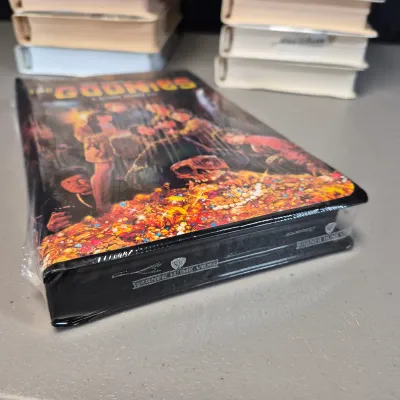LOT 27B: Vintage VHS Clamshell Collection with Sealed "The Goonies" Movie
