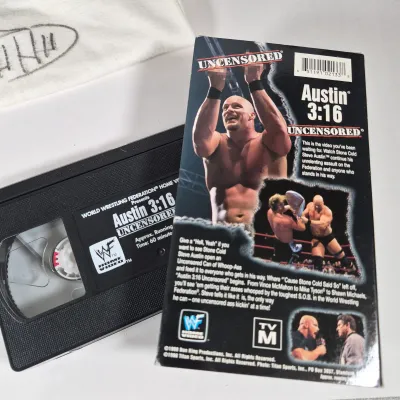 LOT 194Z: WWF Hollywood Hulk Hogan & Stone Cold Steve Austin Collection with Autographed T-shirt by HHH & Steve Austin