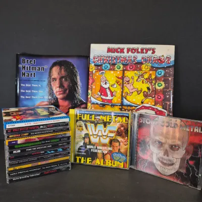 LOT 32B: WWF CD Collection with Mick Foley's Christmas Chaos Book & Bret Hitman Hart Book