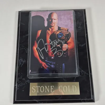 LOT 192Z: Stone Cold & The Rock Autographed Plaques, 1999 WWF WrestleMania T-Shirt & More