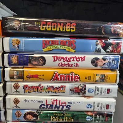 LOT 27B: Vintage VHS Clamshell Collection with Sealed "The Goonies" Movie