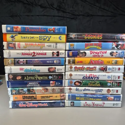 LOT 27B: Vintage VHS Clamshell Collection with Sealed "The Goonies" Movie