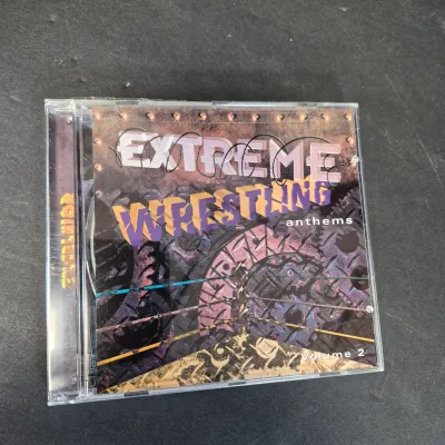 LOT 32B: WWF CD Collection with Mick Foley's Christmas Chaos Book & Bret Hitman Hart Book