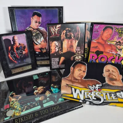 LOT 192Z: Stone Cold & The Rock Autographed Plaques, 1999 WWF WrestleMania T-Shirt & More