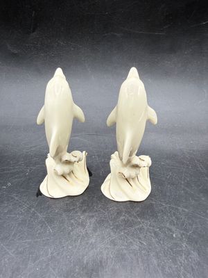 Sale Photo Thumbnail #528: Handcrafted Lenox Dolphin Figurine made of ivory porcelain with 24K gold trim accents, standing about 4 inches tall. Very good condition.