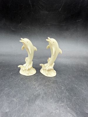 Sale Photo Thumbnail #525: Handcrafted Lenox Dolphin Figurine made of ivory porcelain with 24K gold trim accents, standing about 4 inches tall. Very good condition.