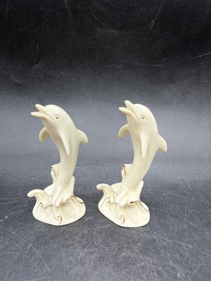 Sale Photo Thumbnail #524: Handcrafted Lenox Dolphin Figurine made of ivory porcelain with 24K gold trim accents, standing about 4 inches tall. Very good condition.