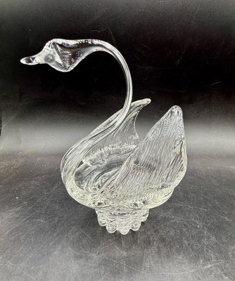 Sale Photo Thumbnail #521: Vintage clear crystal swan trinket dish featuring textured, feather-like wings and an elegant arched neck. Good condition, approx. 6" tall.