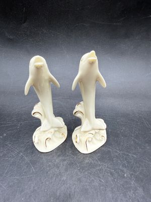 Sale Photo Thumbnail #527: Handcrafted Lenox Dolphin Figurine made of ivory porcelain with 24K gold trim accents, standing about 4 inches tall. Very good condition.