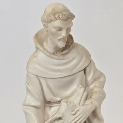 LOT 51: White Devotional Statue of Saint Francis of Assisi Taming the Wolf of Gubbio and Replica Figurine of Michelangelo's Pietà,...