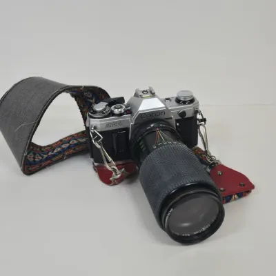 LOT 42: Vintage Canon AE-1 35mm SLR Film Camera with Telephoto Zoom Lense and Strap