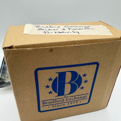 LOT 100: Bradford Exchange Collectibles - Nativity Figurines and World Trade Center Collectible Plate