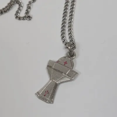 LOT 52: Statue Depicting the Infant Jesus of Prague, Multiple Scapulars, Italian-made Crucifix Pendant, and More