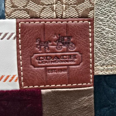 LOT 140: Coach Holiday Patchwork Swing Pack Shoulder Bag