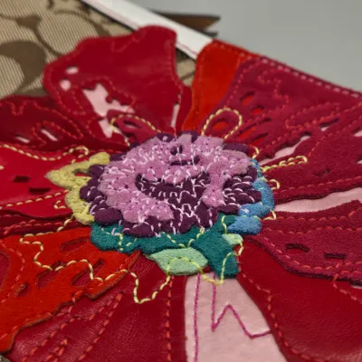 LOT 143: Coach Signature Poppy Floral Demi Clutch