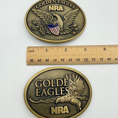LOT 81: Two NRA Golden Eagles Commemorative Belt Buckles