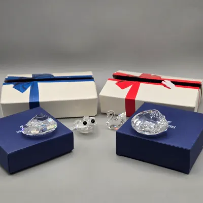 LOT 122: SWAROVSKI Crystal Snail Shell Wonder of The Sea, Scalloped Shell, Swan, and Frog Prince Figurines/ All in Original Boxes