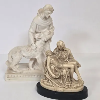 LOT 51: White Devotional Statue of Saint Francis of Assisi Taming the Wolf of Gubbio and Replica Figurine of Michelangelo's Pietà,...