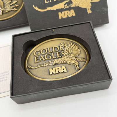 LOT 81: Two NRA Golden Eagles Commemorative Belt Buckles