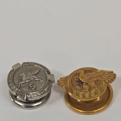 LOT 54: Swank Tie Pin with Matching Cufflinks, Vintage Caravelle Wristwatch, Socony Gas 5 Year Pin, Gold-tone WWII Honorable Discharge...