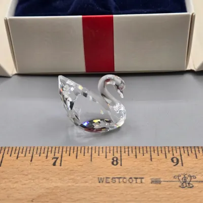 LOT 122: SWAROVSKI Crystal Snail Shell Wonder of The Sea, Scalloped Shell, Swan, and Frog Prince Figurines/ All in Original Boxes