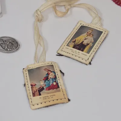 LOT 52: Statue Depicting the Infant Jesus of Prague, Multiple Scapulars, Italian-made Crucifix Pendant, and More